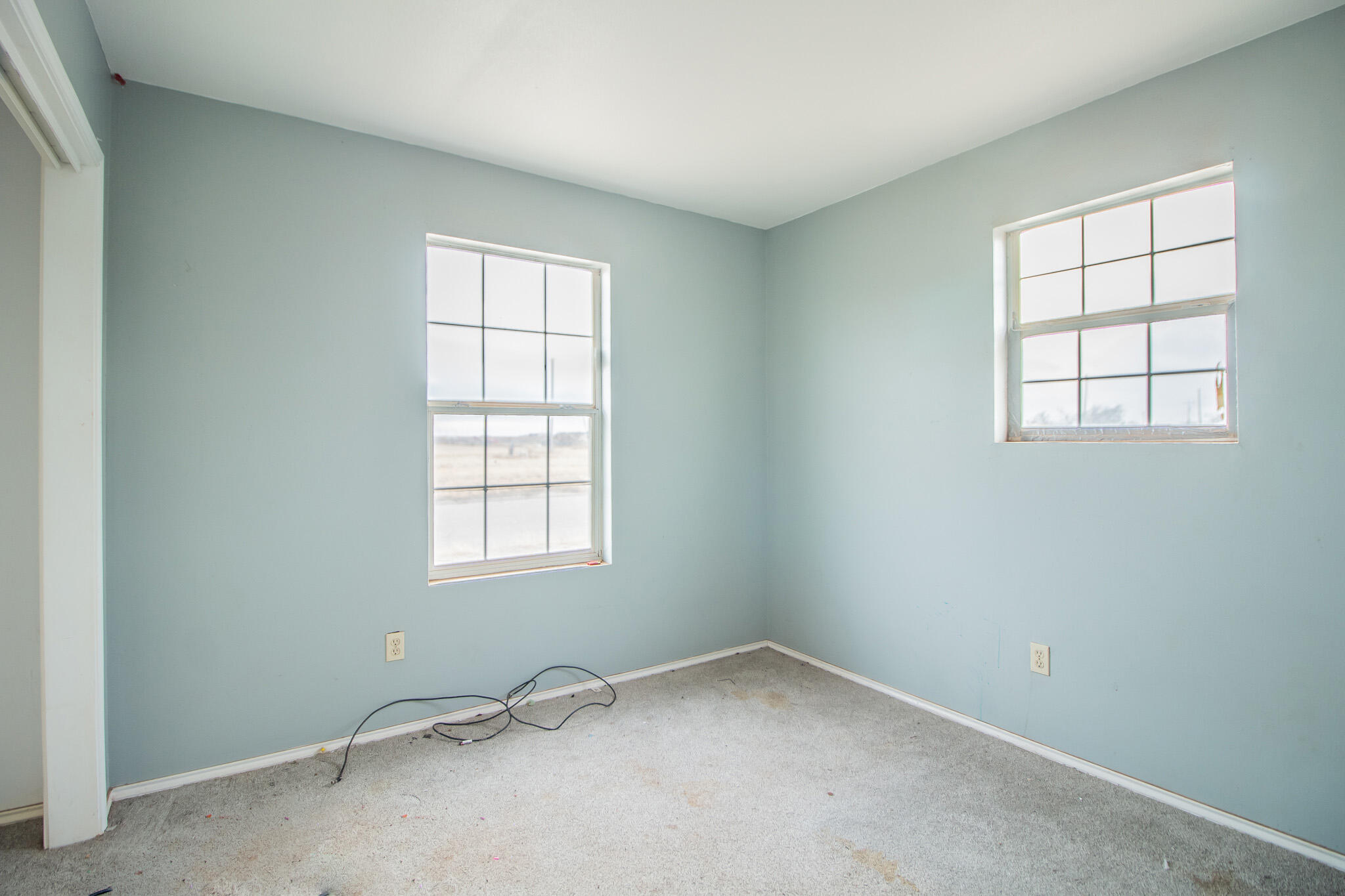 1355 South 3rd Street Slaton, TX 79364 - Photo 12 of 14 an empty room with a window