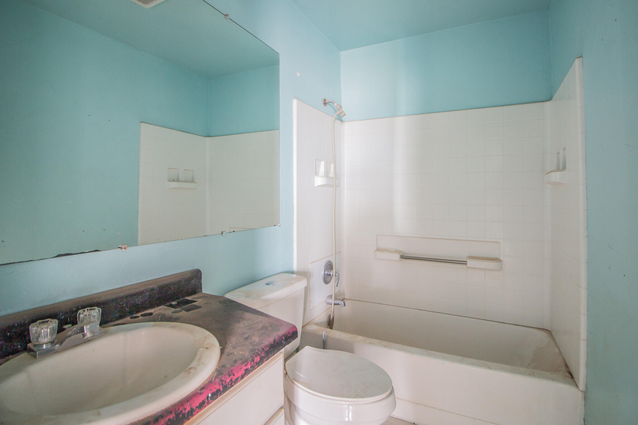 1355 South 3rd Street Slaton, TX 79364 - Photo 13 of 14 a bathroom with a sink and a mirror