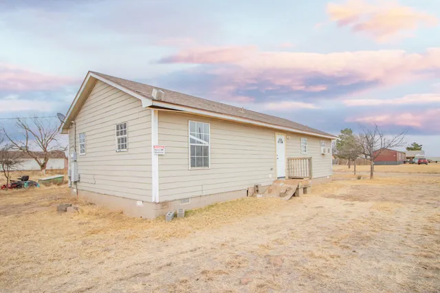 a view of a house with a snow on the road