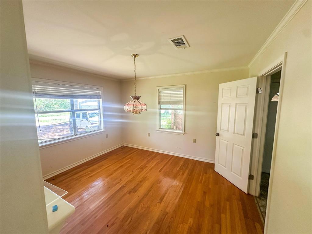 894 Percy Burns Road Springhill, LA 71075 - Photo 3 of 8 a view of empty room with wooden floor and fan