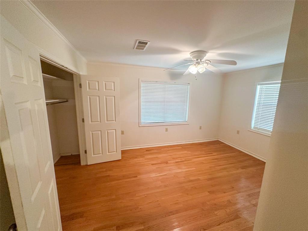 894 Percy Burns Road Springhill, LA 71075 - Photo 4 of 8 an empty room with windows and fan