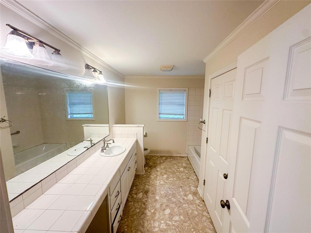 894 Percy Burns Road Springhill, LA 71075 - Photo 7 of 8 a spacious bathroom with a tub sink and mirror