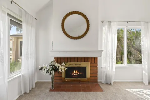 a living room with a fireplace and a large window