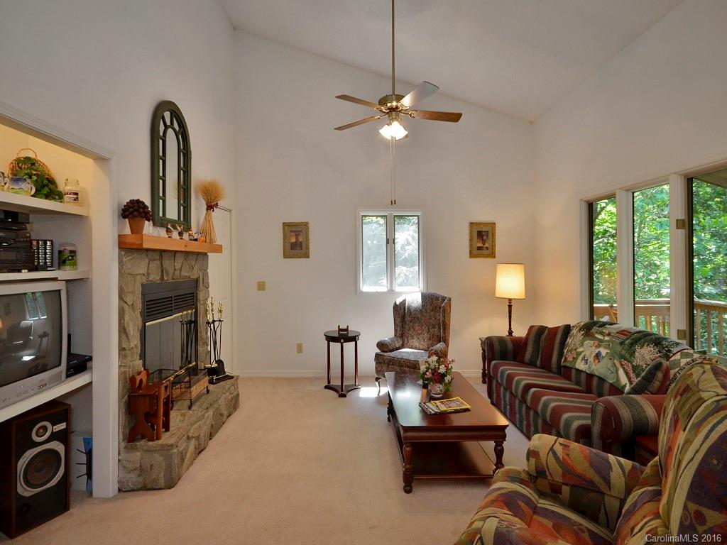51 Forest Road, Unit 51 Canton, NC 28716 - Photo 4 of 14 a living room with furniture a fireplace and a flat screen tv
