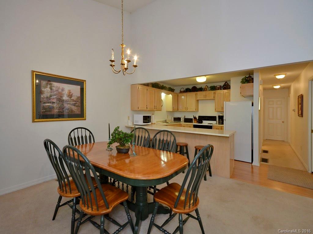 51 Forest Road, Unit 51 Canton, NC 28716 - Photo 5 of 14 a view of a dining room with furniture and a chandelier