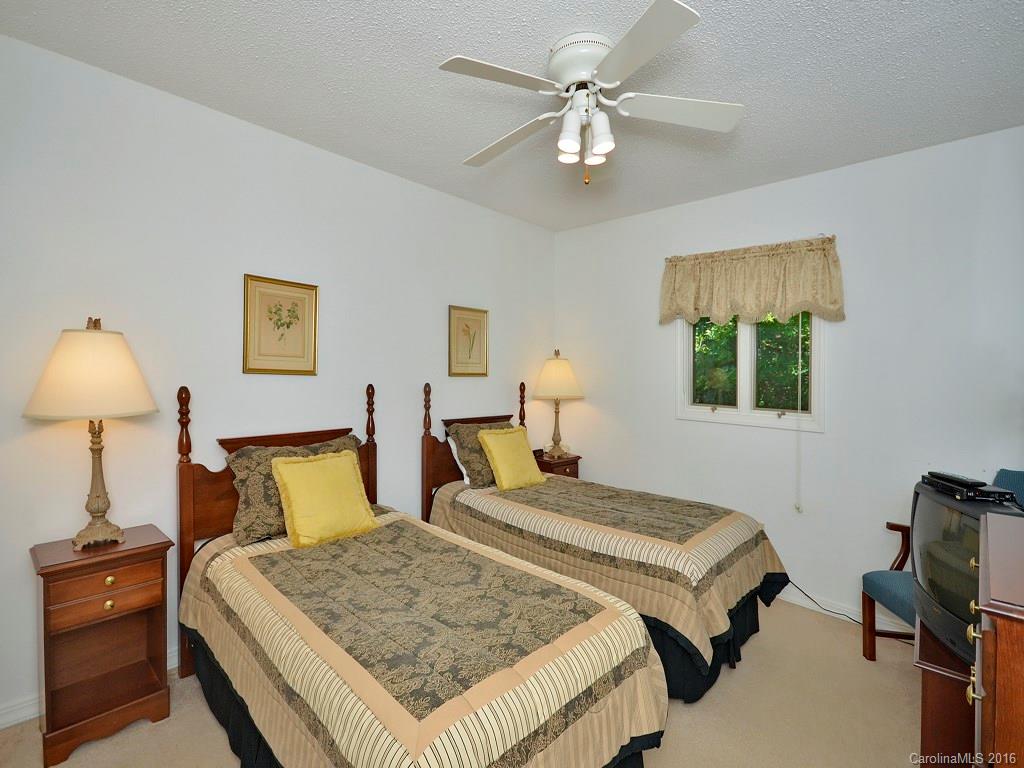 51 Forest Road, Unit 51 Canton, NC 28716 - Photo 7 of 14 a bedroom with a bed and a chandelier