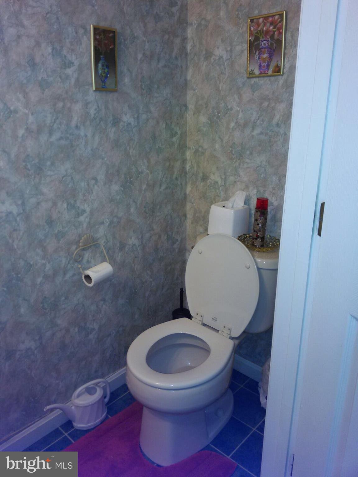 7006 Pinecrest Road Baltimore, MD 21228 - Photo 14 of 30 a white toilet sitting next to a small bathroom