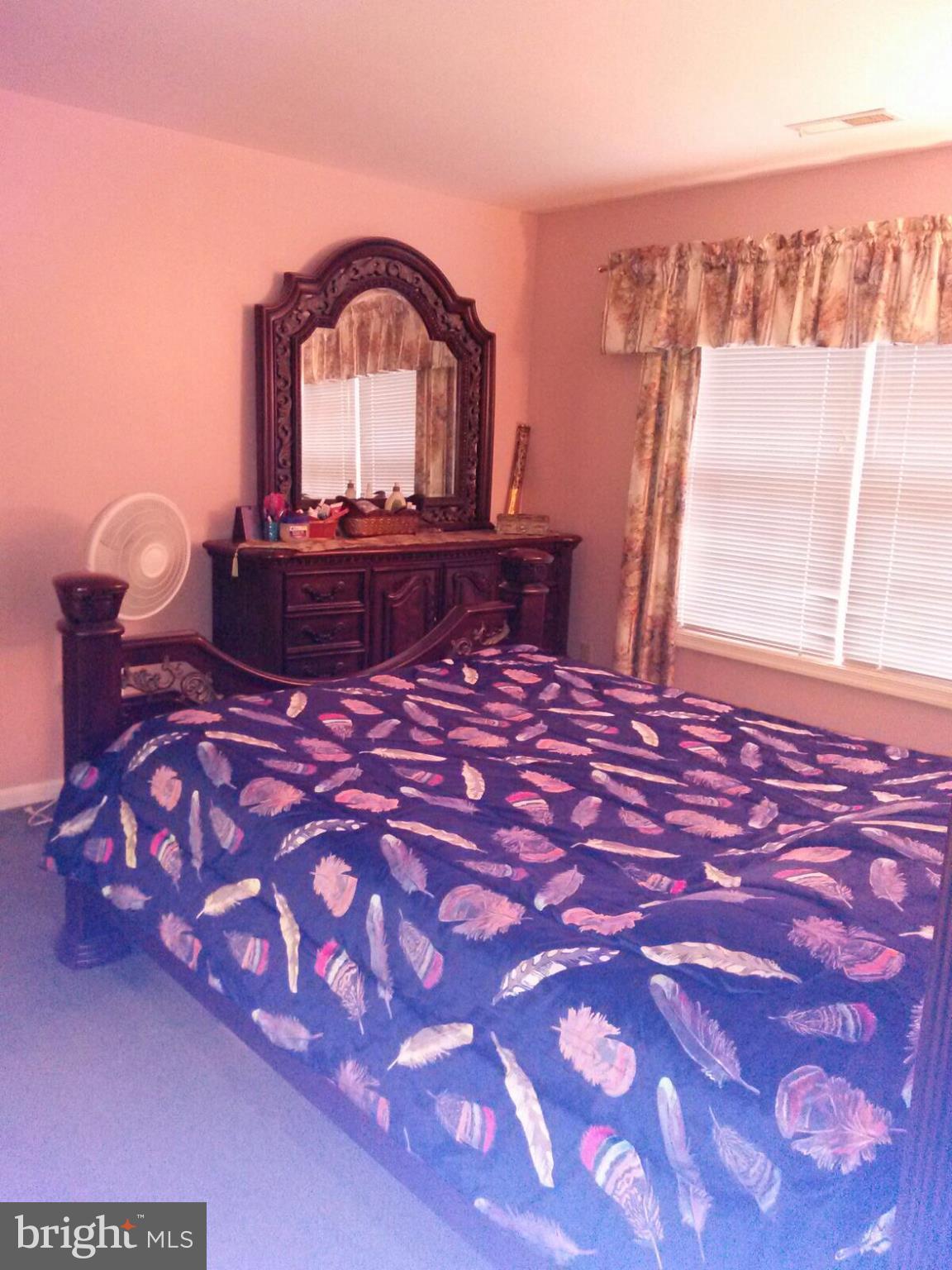 7006 Pinecrest Road Baltimore, MD 21228 - Photo 22 of 30 a large bed with a black and white comforter