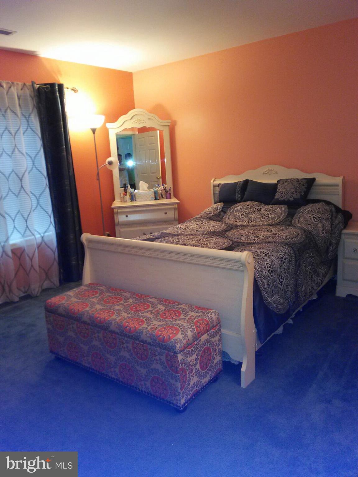 7006 Pinecrest Road Baltimore, MD 21228 - Photo 23 of 30 a spacious bedroom with a bed and wooden floor