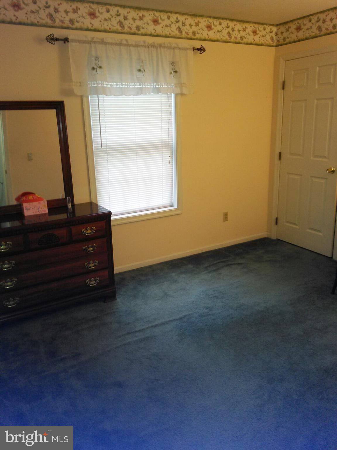 7006 Pinecrest Road Baltimore, MD 21228 - Photo 25 of 30 a room that has a bed in it