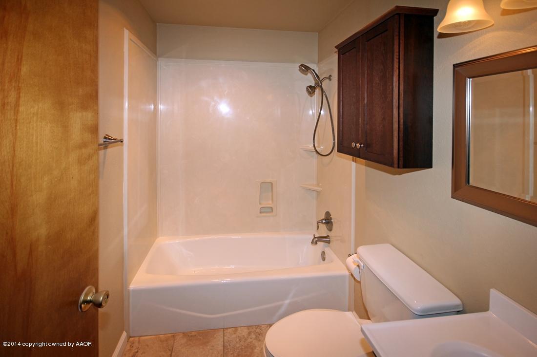 8105 Marni Trail Amarillo, TX 79110 - Photo 14 of 30 a bathroom with a toilet and a bathtub