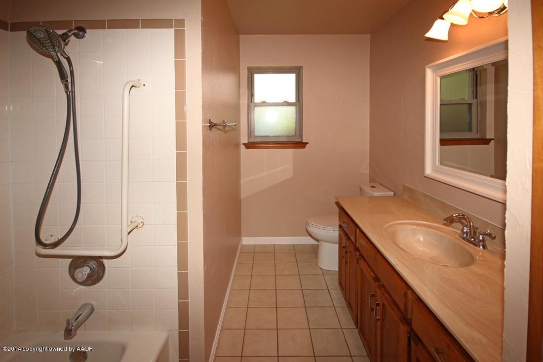8105 Marni Trail Amarillo, TX 79110 - Photo 24 of 30 a bathroom with a granite countertop shower a sink and a mirror