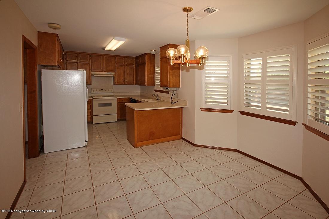 8105 Marni Trail Amarillo, TX 79110 - Photo 7 of 30 a view of a kitchen with windows and refrigerator