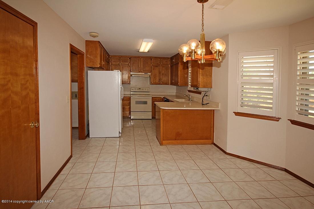 8105 Marni Trail Amarillo, TX 79110 - Photo 8 of 30 a kitchen with stainless steel appliances granite countertop a refrigerator and a sink