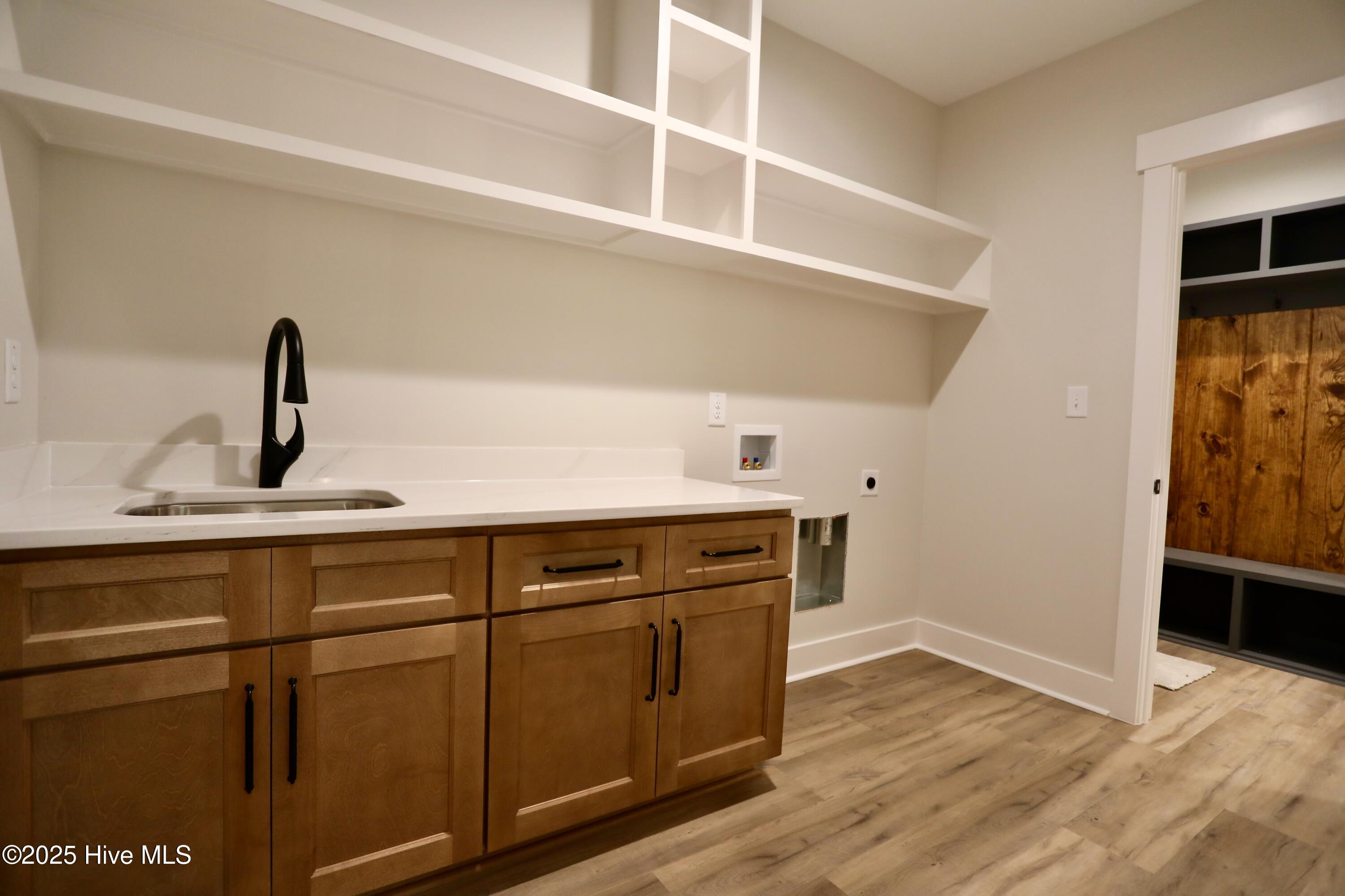 130 Gails Road West End, NC 27376 - Photo 32 of 61 Oversized laundry w/sink & cabinetry + overhead wood shelving
