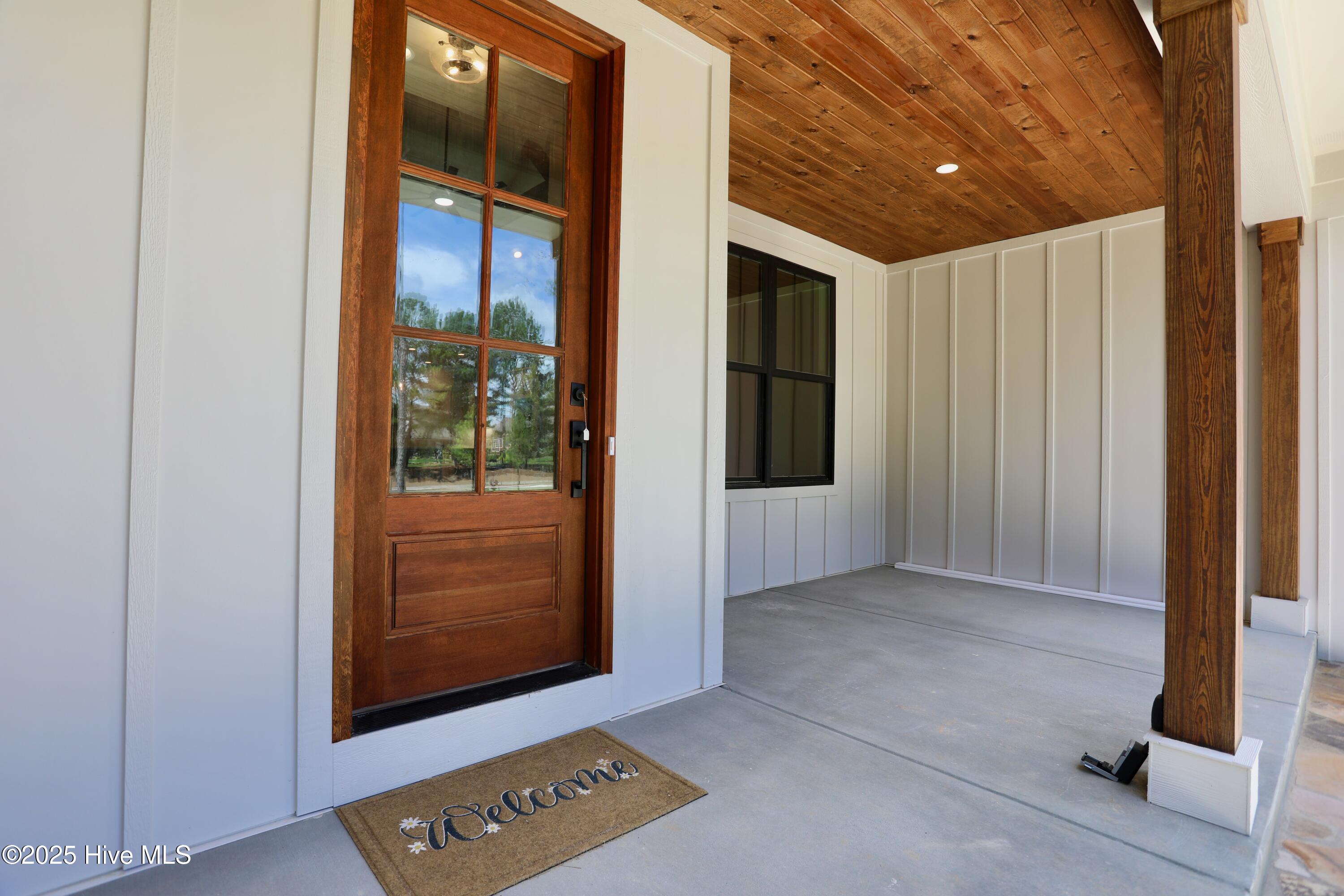 130 Gails Road West End, NC 27376 - Photo 4 of 61 Gorgeous front entrance wood accents - door, ceiling & columns!