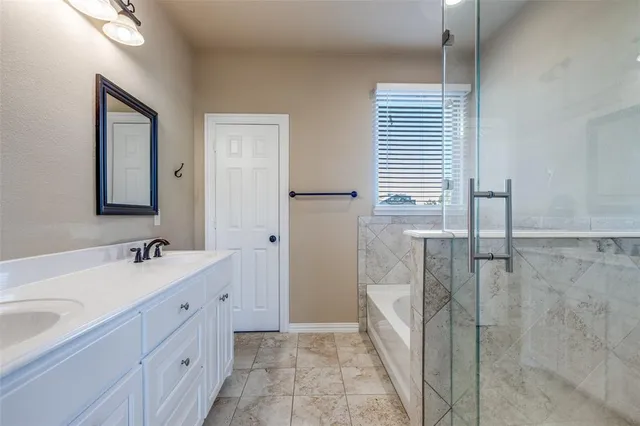 a bathroom with a double vanity sink a and mirror
