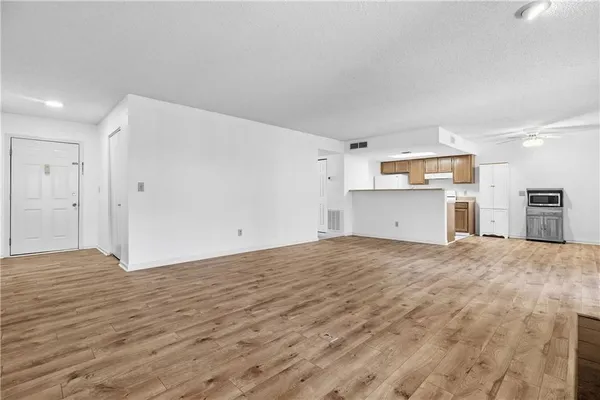 a view of a room with wooden floor and a sink