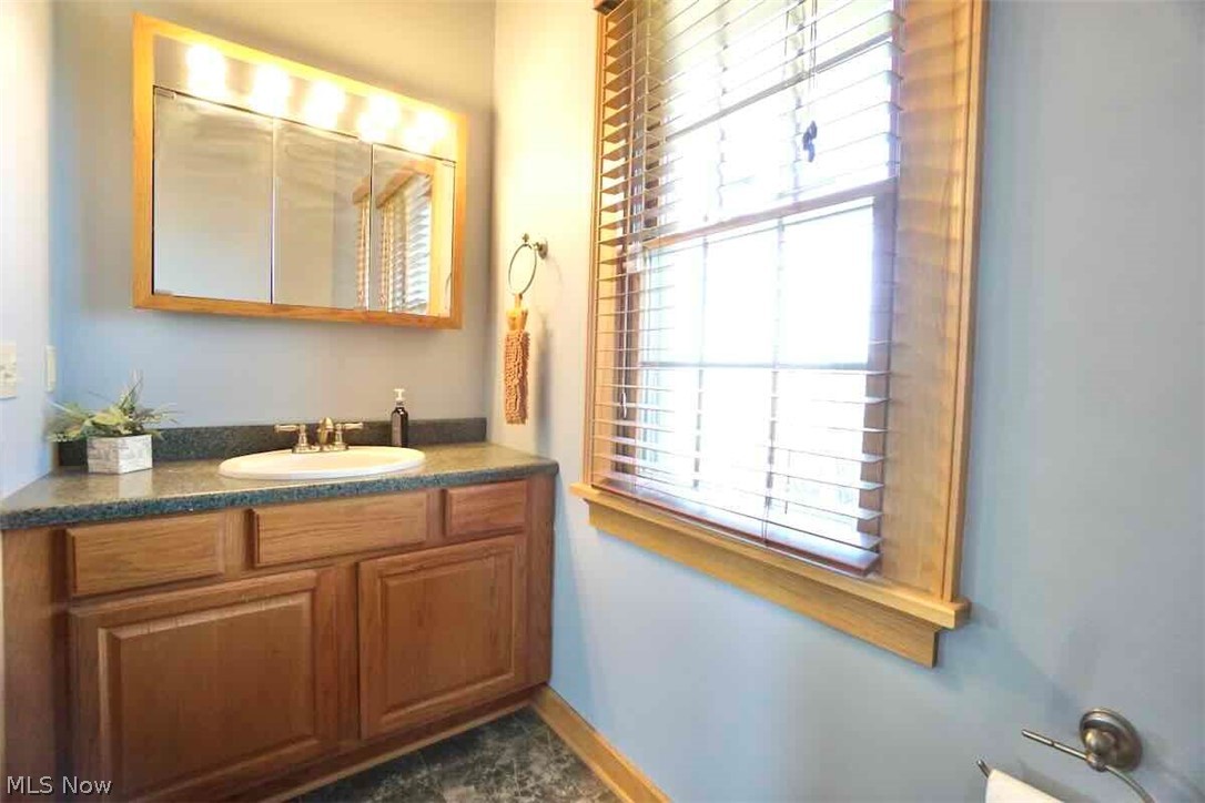 9835 Kile Road Chardon, OH 44024 - Photo 13 of 40 1st fl. half bath with a wealth of natural light and vanity