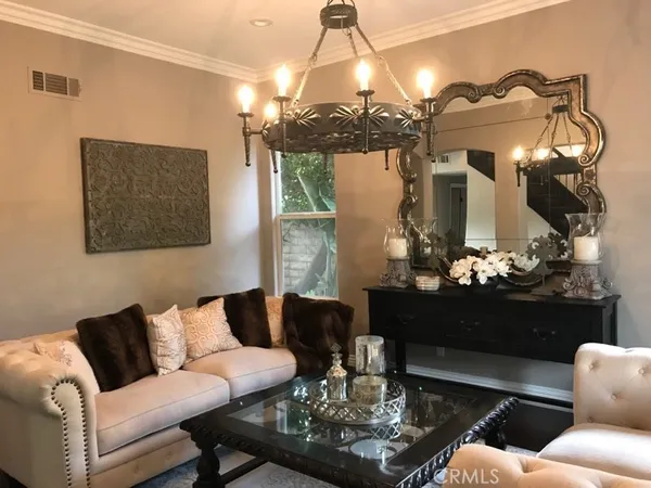 a living room with furniture a chandelier and a chandelier