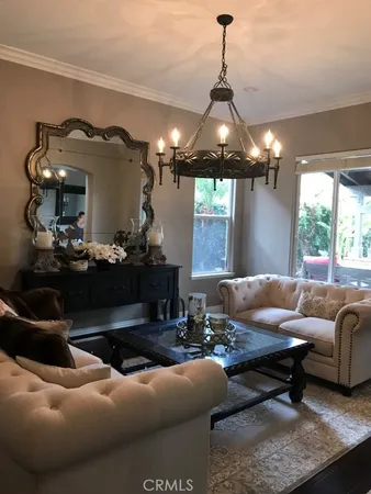 a living room with furniture and a chandelier