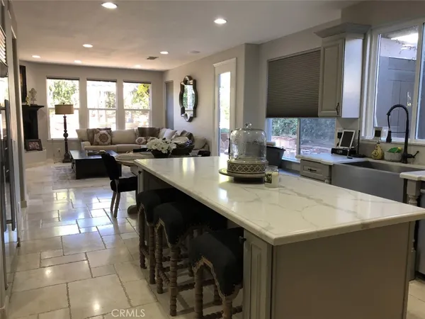 a kitchen with a sink a counter and chairs