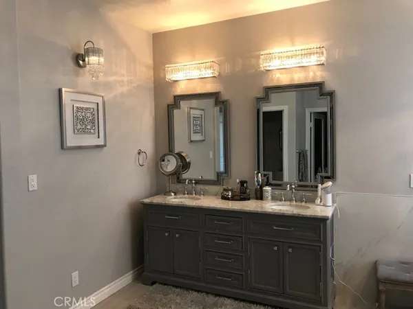 a bathroom with a double vanity sink and a mirror