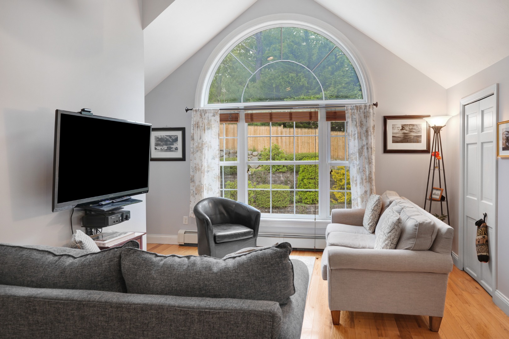 8 Fresh Pond Road Oak Bluffs, MA 02557 - Photo 17 of 36 a living room with furniture a flat screen tv and a large window