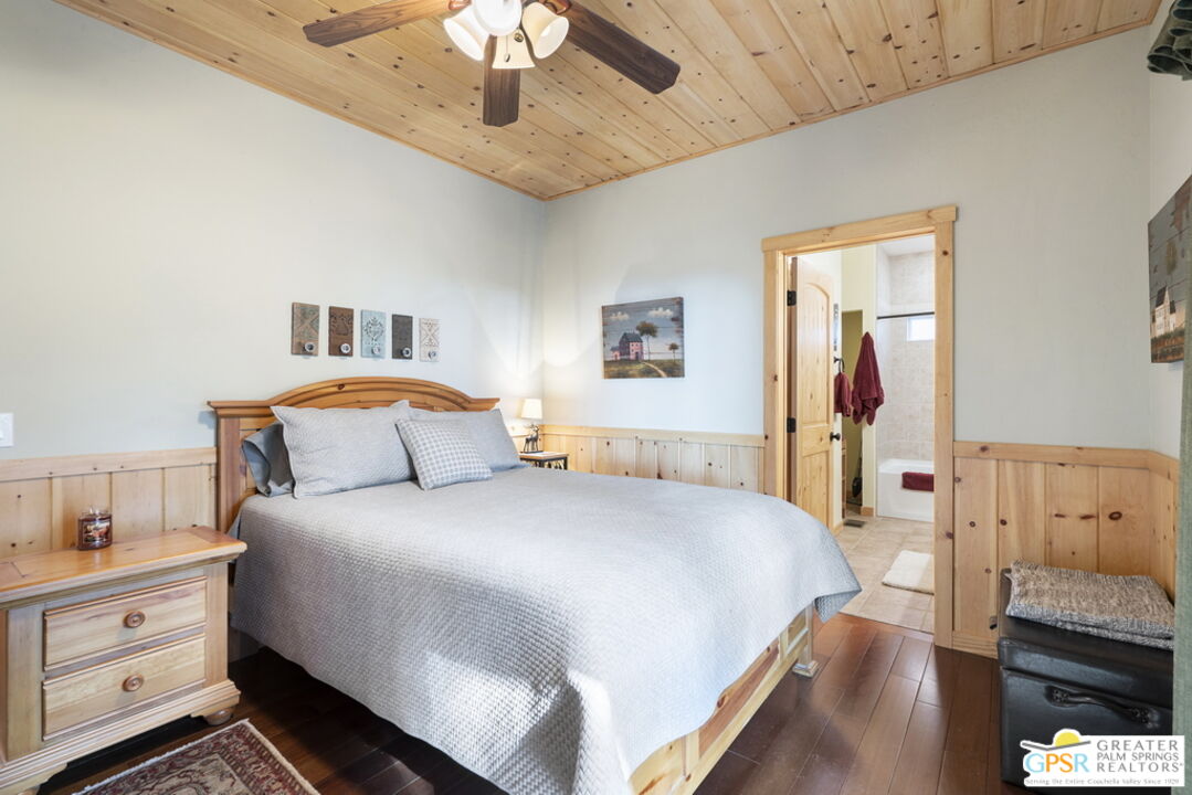 52352 Pine Ridge Road Idyllwild, CA 92549 - Photo 21 of 73 a bedroom with a bed and a chandelier