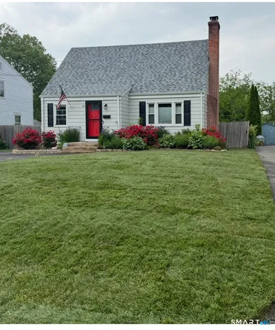 a front view of house with yard and outdoor seating