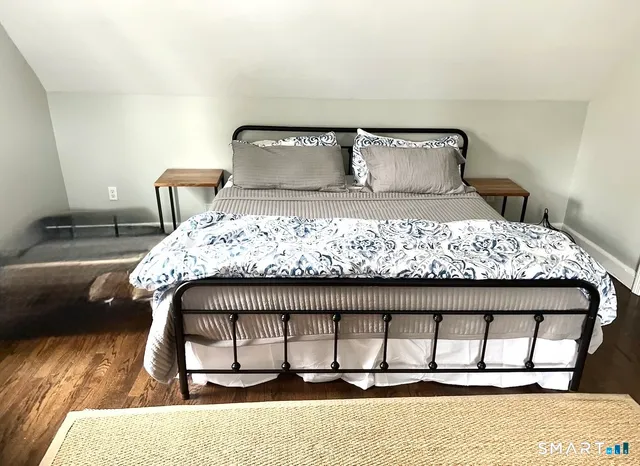 a bedroom with a bed and a night stand