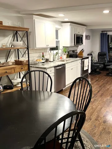 a kitchen with a dining table chairs and a dining table