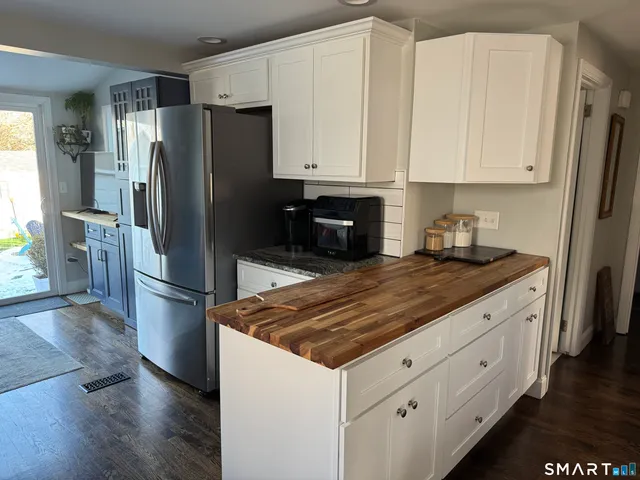 a kitchen with stainless steel appliances a refrigerator sink and cabinets
