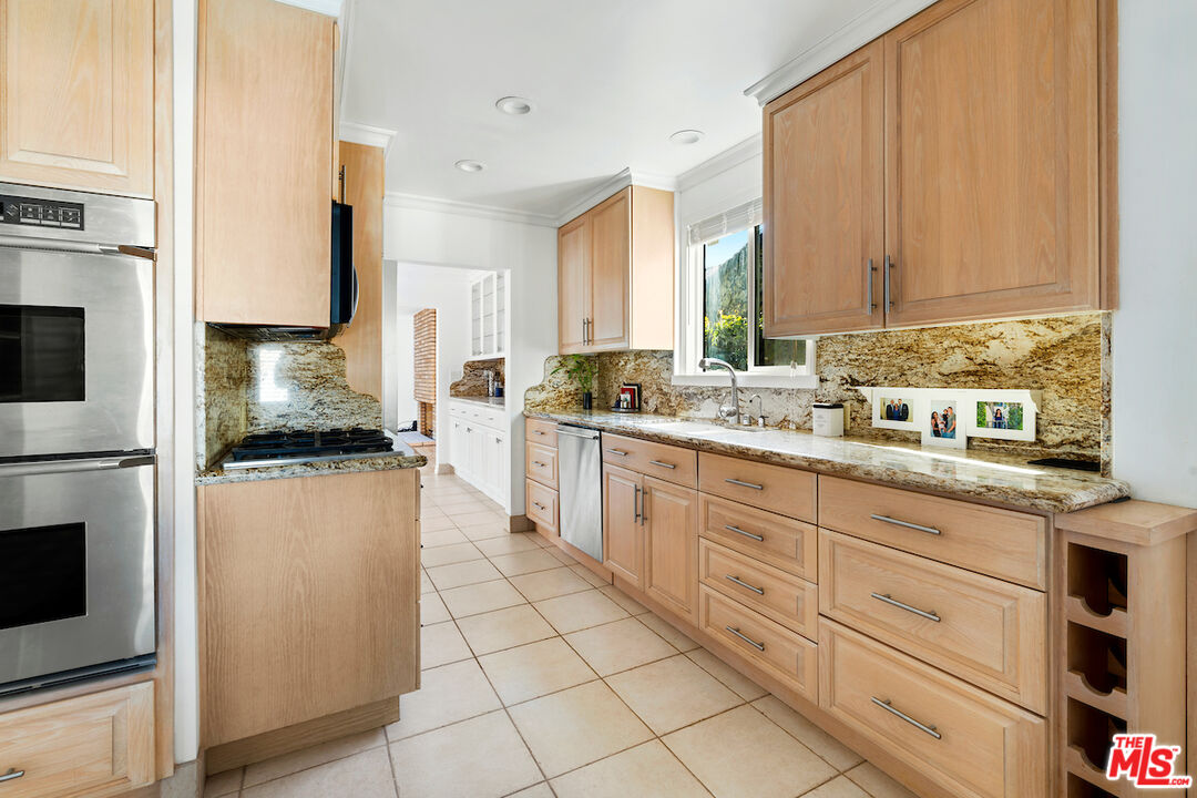 3381 Colbert Avenue Los Angeles, CA 90066 - Photo 12 of 24 a kitchen with granite countertop white cabinets and white appliances