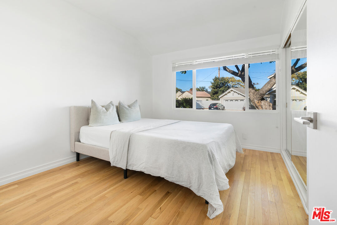 3381 Colbert Avenue Los Angeles, CA 90066 - Photo 14 of 24 a bedroom with a bed and a painting on the wall