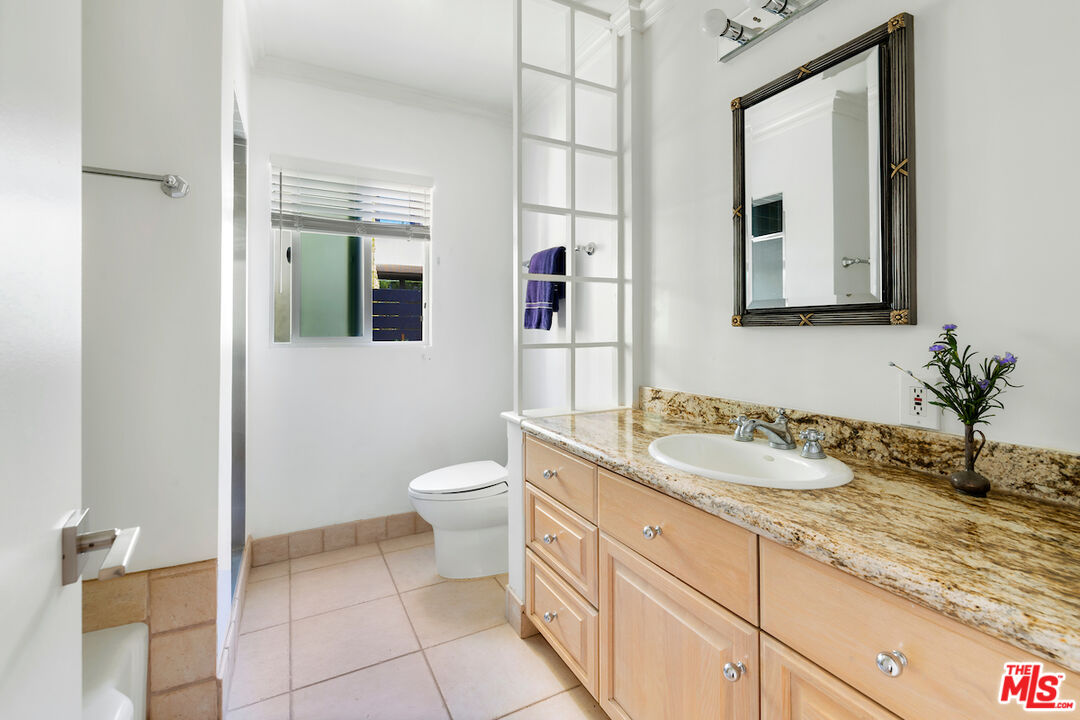 3381 Colbert Avenue Los Angeles, CA 90066 - Photo 16 of 24 a bathroom with a granite countertop sink mirror and toilet