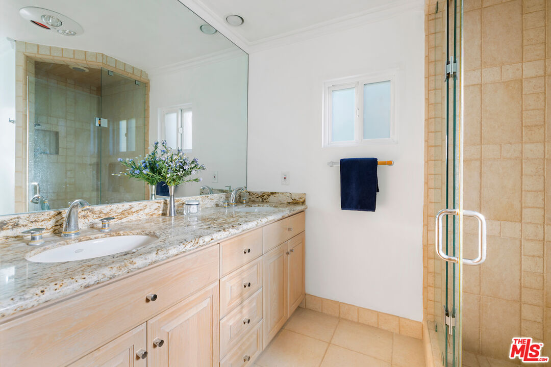 3381 Colbert Avenue Los Angeles, CA 90066 - Photo 20 of 24 a bathroom with a granite countertop sink a mirror and shower