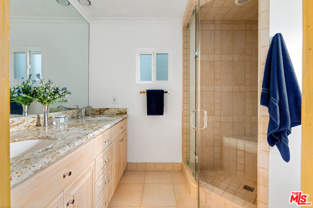 3381 Colbert Avenue Los Angeles, CA 90066 - Photo 21 of 24 a bathroom with a granite countertop sink a mirror and shower