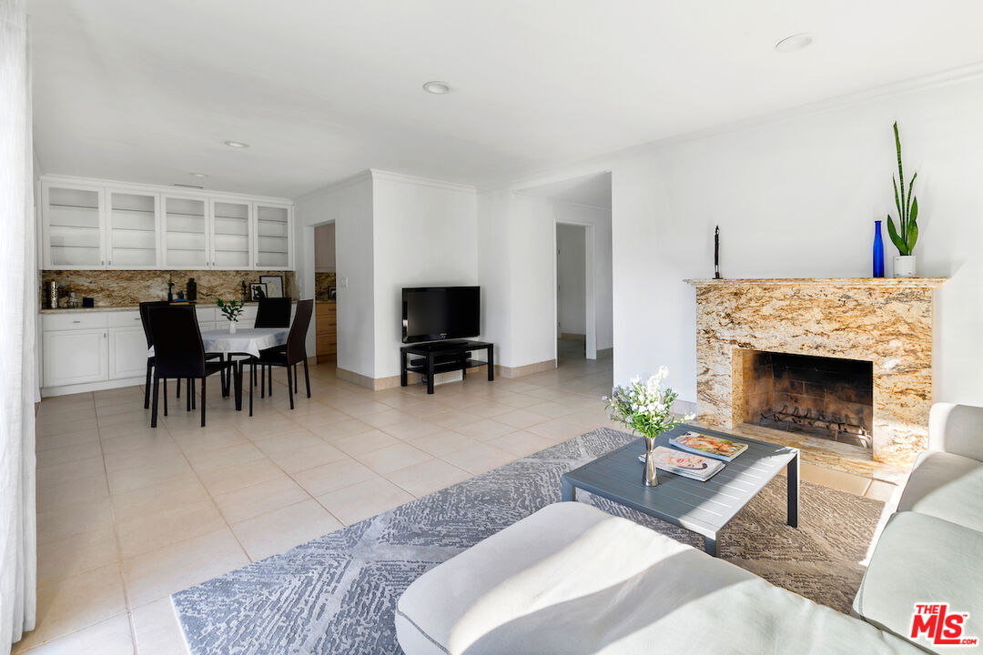 3381 Colbert Avenue Los Angeles, CA 90066 - Photo 7 of 24 a living room with furniture a fireplace and a table