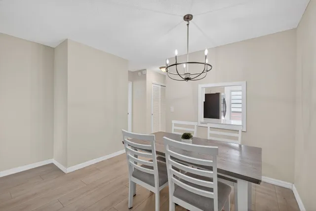 a view of a dining room with furniture wooden floor and chandelier