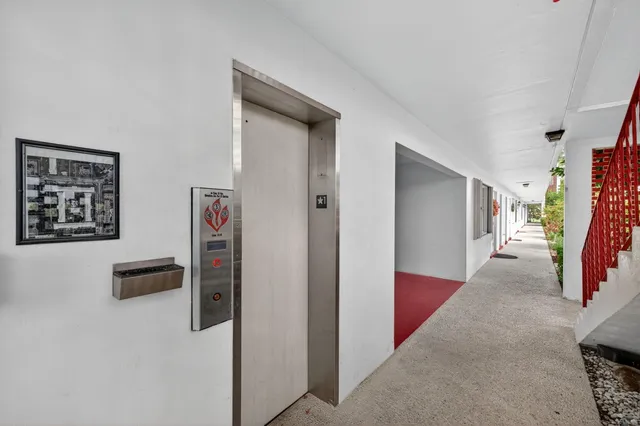 a view of a hallway with paintings on the wall