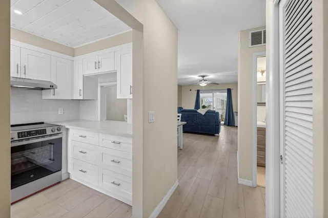a kitchen with cabinets and wooden floor