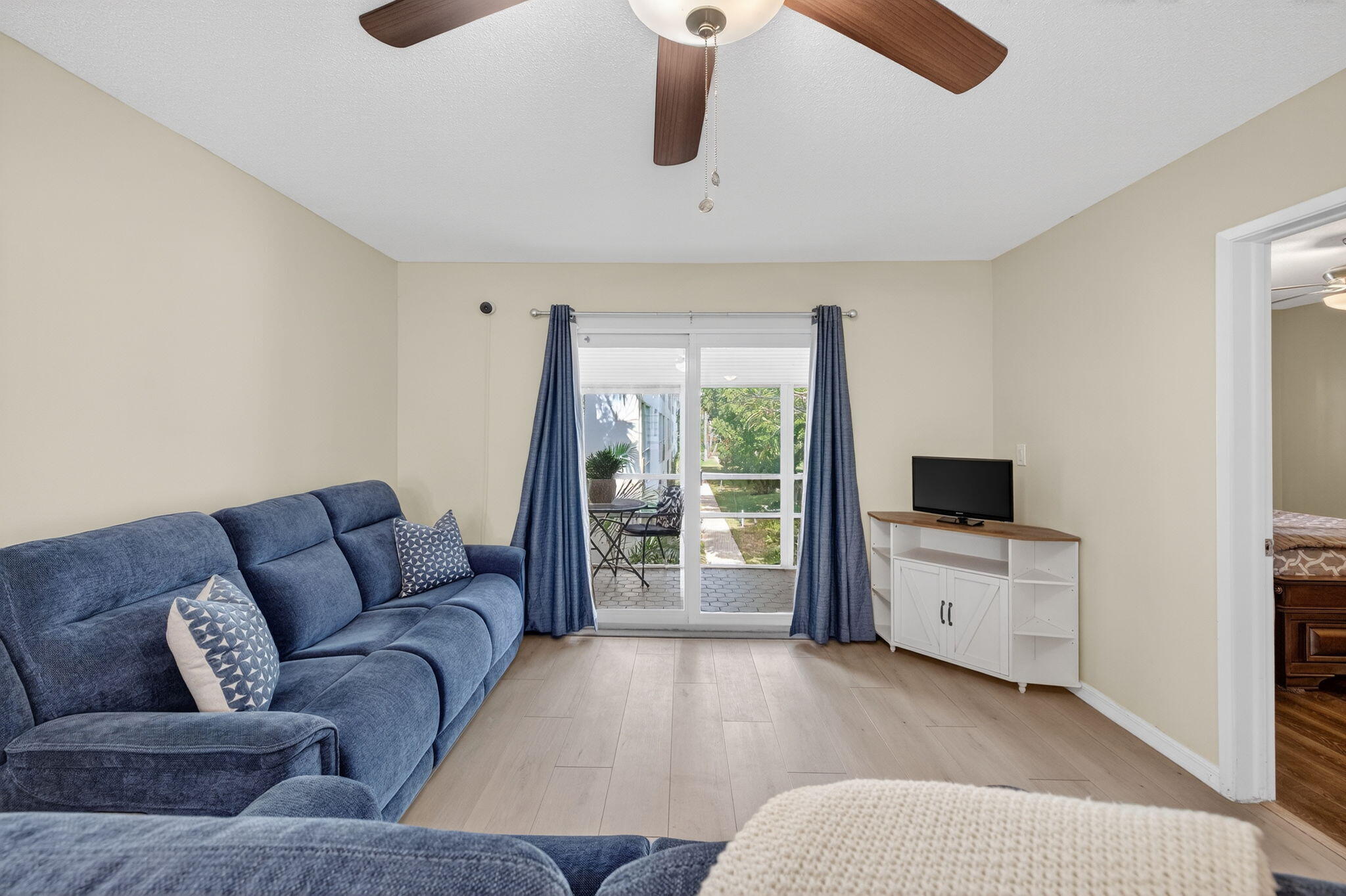 2050 Northeast 39th Street, Unit S210 Lighthouse Point, FL 33064 - Photo 8 of 46 a living room with furniture and a flat screen tv