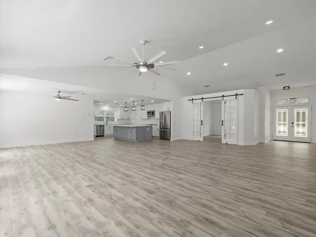 a view of wooden floor and entryway in a room