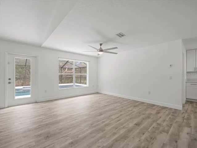 a kitchen with granite countertop white cabinets and a window