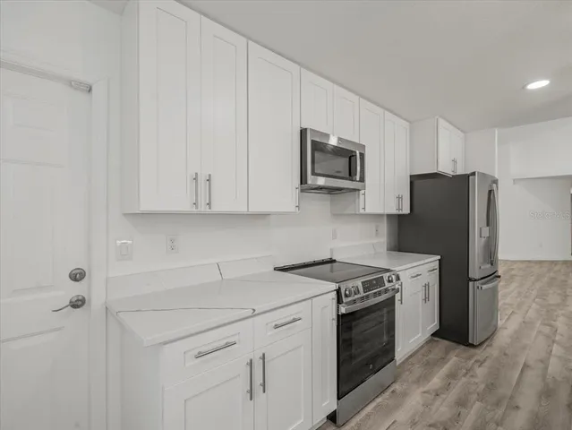 a spacious bathroom with a double vanity sink a mirror and shower