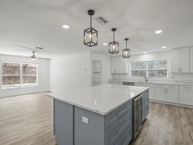 a white bath tub sitting in a bathroom next to a window