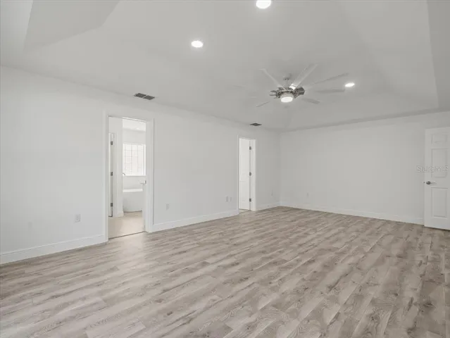 a view of a room with wooden floor