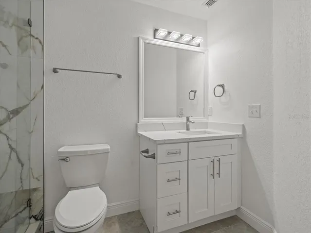 an aerial view of a house with a yard and lake view