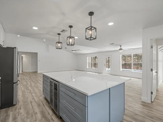 a view of a hallway with wooden floor and a window
